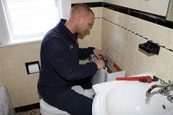 Jack is in the bathroom repairing the toilet